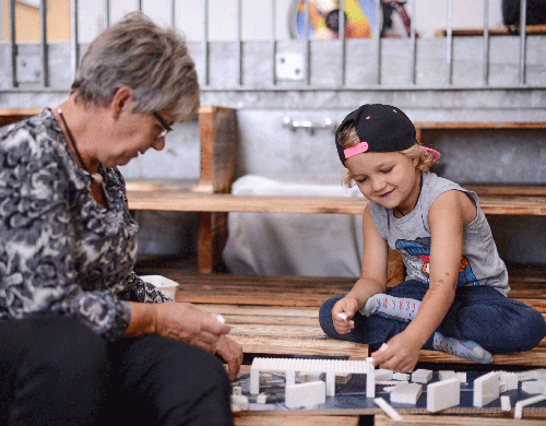 Grandmother and grandson building