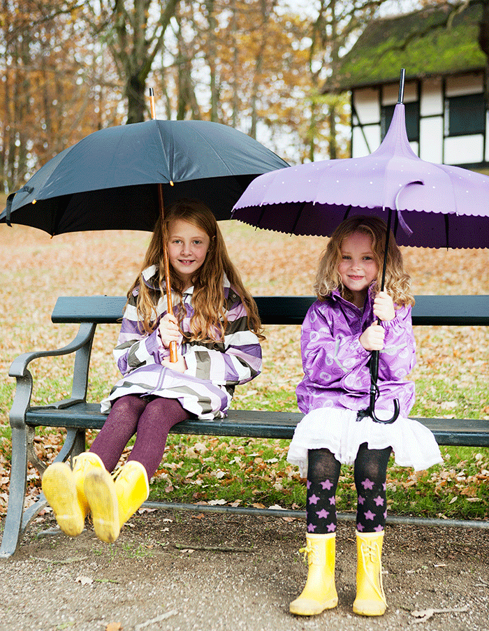 Two-Girls-with-umbrella-on-bench